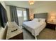Comfortable bedroom with a large window, soft lighting, and cozy furnishings at 8949 Coconut Breeze Dr, Kissimmee, FL 34747