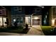 Modern home with stone accents, a dark garage door and a well-maintained lawn at nighttime at 8949 Coconut Breeze Dr, Kissimmee, FL 34747