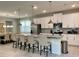 Modern kitchen with stainless steel appliances, granite countertops, and an adjacent dining area at 8949 Coconut Breeze Dr, Kissimmee, FL 34747