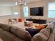Comfortable living room with a large sectional sofa and a modern entertainment center at 8949 Coconut Breeze Dr, Kissimmee, FL 34747