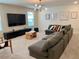 Spacious bonus room with comfortable seating and modern lighting fixture at 8949 Coconut Breeze Dr, Kissimmee, FL 34747