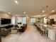 Open floor plan combines living, dining, and kitchen areas, featuring a large island and modern finishes at 8949 Coconut Breeze Dr, Kissimmee, FL 34747
