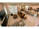 Open-concept living room and kitchen with modern furnishings and tile flooring at 8949 Coconut Breeze Dr, Kissimmee, FL 34747