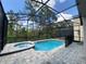 Enclosed backyard oasis featuring a pool, spa, and paved patio area for relaxation and entertaining at 8949 Coconut Breeze Dr, Kissimmee, FL 34747