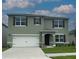 Charming two-story home features a two-car garage, tidy landscaping, and decorative shutters at 919 Princess Sabal Pt, Haines City, FL 33844