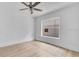 A bright bedroom with wood flooring, a ceiling fan, and a large window at 1029 Colyer St, Orlando, FL 32805