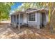 Charming exterior view of a blue single-story home with a covered porch and a mature tree at 1029 Colyer St, Orlando, FL 32805