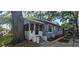 Quaint exterior view of the home, featuring a screened front porch and well-maintained landscaping at 1029 Colyer St, Orlando, FL 32805
