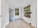 Bright flex space with wood flooring, a hot water heater, and multiple windows at 1029 Colyer St, Orlando, FL 32805
