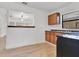 Bright kitchen with stainless steel sink, wood cabinetry, and light wood flooring at 1029 Colyer St, Orlando, FL 32805