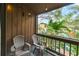 Private balcony with chairs offers a serene outdoor escape with lush greenery and a peaceful neighborhood view at 1038 E Michigan St # B, Orlando, FL 32806