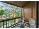 Relaxing balcony with two chairs and view of lush greenery at 1038 E Michigan St # B, Orlando, FL 32806