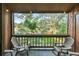 Relaxing balcony featuring comfortable seating and tranquil views of verdant foliage and nearby residences at 1038 E Michigan St # B, Orlando, FL 32806