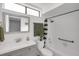 Bright bathroom featuring a single sink vanity and a shower-tub combo with stylish shower curtain at 1038 E Michigan St # B, Orlando, FL 32806