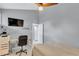 Bedroom with a twin bed, desk and ceiling fan, complete with neutral paint and white trim at 1038 E Michigan St # B, Orlando, FL 32806