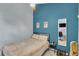 Bedroom with a comfortable bed, grey walls, and a gold tuba placed on the carpeted floor at 1038 E Michigan St # B, Orlando, FL 32806