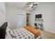 Bedroom with a twin bed, closet and ceiling fan, complete with neutral paint and white trim at 1038 E Michigan St # B, Orlando, FL 32806