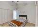 Bedroom with a twin bed, closet and ceiling fan, complete with neutral paint and white trim at 1038 E Michigan St # B, Orlando, FL 32806