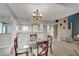 Open-concept dining room with a glass table, stylish chairs, and seamless flow to the kitchen and living areas at 1038 E Michigan St # B, Orlando, FL 32806