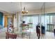 Bright dining room features a glass table, wood chairs, and sliding glass doors leading to a private balcony at 1038 E Michigan St # B, Orlando, FL 32806