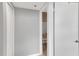Hallway view showcasing bedroom door and walk in closet with neutral color scheme at 1038 E Michigan St # B, Orlando, FL 32806