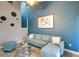 Charming living room with elegant decor, a comfortable sofa, and picturesque views from the adjacent balcony at 1038 E Michigan St # B, Orlando, FL 32806