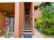 Close-up of stairs leading to condo entrance, surrounded by green landscaping at 1038 E Michigan St # B, Orlando, FL 32806
