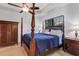 Bedroom showcasing a wooden wardrobe, a decorative four poster bed, and neutral carpeting at 10412 Henbury St, Orlando, FL 32832