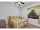 Cozy bedroom with tropical-themed bedding and a ceiling fan at 10412 Henbury St, Orlando, FL 32832