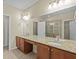 Bathroom boasts double sinks, granite countertops, and a glass-enclosed shower at 1208 Bella Rose Ct, Davenport, FL 33896
