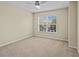 Bedroom with a carpet, a ceiling fan, and a large window at 1208 Bella Rose Ct, Davenport, FL 33896