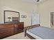 Bedroom featuring hardwood dresser and bathroom access at 1208 Bella Rose Ct, Davenport, FL 33896