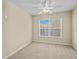 Bedroom with a carpet, a ceiling fan, and a large window at 1208 Bella Rose Ct, Davenport, FL 33896