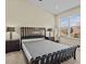 Bedroom features a modern bed frame, neutral walls, and an abundance of natural light at 1208 Bella Rose Ct, Davenport, FL 33896