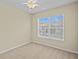 Bedroom with large window, carpet, and ceiling fan at 1208 Bella Rose Ct, Davenport, FL 33896