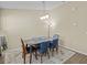 Dining room with modern lighting, wood-style floors, and seating for six at 1208 Bella Rose Ct, Davenport, FL 33896