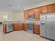 Modern kitchen featuring stainless steel appliances, wooden cabinets and granite countertops at 1208 Bella Rose Ct, Davenport, FL 33896