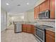 Open-concept kitchen with stainless steel appliances, a breakfast bar, and tile flooring at 1208 Bella Rose Ct, Davenport, FL 33896