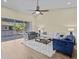 Bright living room with high ceilings, ceiling fan, wood floors, and sliding glass doors to balcony at 1208 Bella Rose Ct, Davenport, FL 33896
