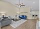 Spacious living room with vaulted ceiling, ceiling fan, and open floor plan at 1208 Bella Rose Ct, Davenport, FL 33896