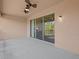 Covered patio area with ceiling fan and sliding glass doors at 1208 Bella Rose Ct, Davenport, FL 33896
