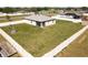 Aerial view of the property, featuring a spacious fenced yard and lush landscaping at 12524 Garrett Pl, Grand Island, FL 32735