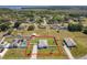 Aerial view of home highlighting property lines, showcasing a well-maintained yard in a quiet, established neighborhood at 12524 Garrett Pl, Grand Island, FL 32735