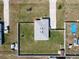 A bird's eye view of the backyard with a fence, a storage shed, and ample greenery at 12524 Garrett Pl, Grand Island, FL 32735