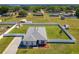 Expansive fenced property featuring a well-maintained lawn, complemented by a detached storage unit and carport at 12524 Garrett Pl, Grand Island, FL 32735