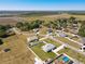 An aerial view shows the home's setting, surrounded by lush landscaping and farmland, a peaceful environment at 12524 Garrett Pl, Grand Island, FL 32735