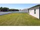 Expansive backyard enclosed by a pristine white fence, offering privacy and ample space at 12524 Garrett Pl, Grand Island, FL 32735