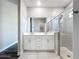 Bathroom features double sink vanity, tiled floor and glass shower at 12524 Garrett Pl, Grand Island, FL 32735