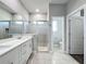 Bathroom features double sink vanity, tiled floor and glass shower at 12524 Garrett Pl, Grand Island, FL 32735