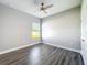 Bedroom offering a ceiling fan, wood-look floors, a window, and neutral paint at 12524 Garrett Pl, Grand Island, FL 32735